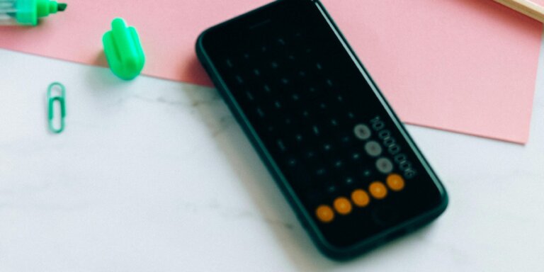 mobile phone showing calculator on a desk