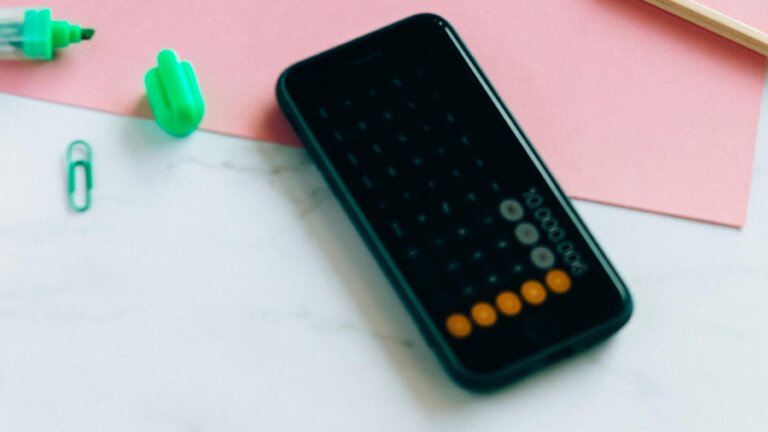 mobile phone showing calculator on a desk